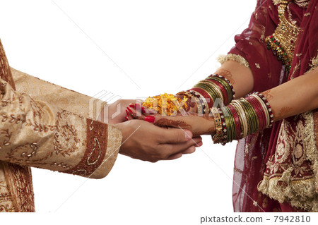 Close-up of bride and grooms hands with marigold 7942810