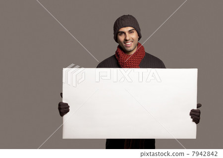 Portrait of young smiling man holding bill board over colored background 7942842