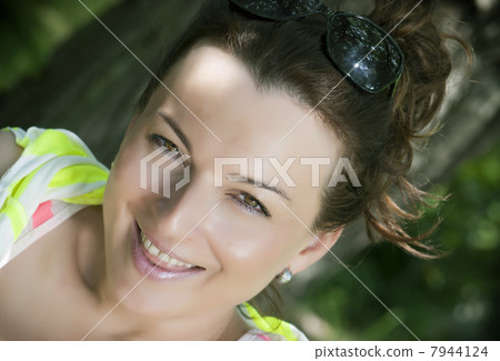 Cheerful young brunette in park 7944124