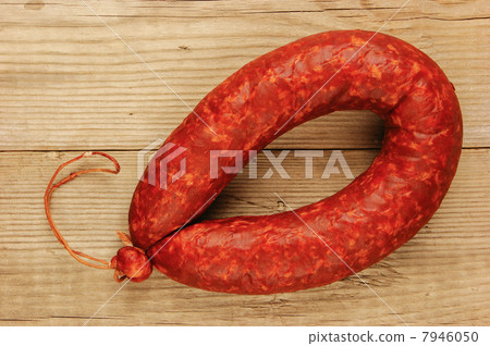 Krakow sausage isolated on the wooden table 7946050