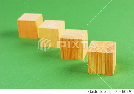 wooden geometric cube on a green background wooden geometric cube on a green background 7946059