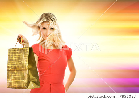 Beautiful young woman with a bag over abstract yellow background 7955083