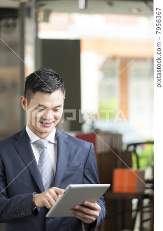 Chinese man with a tablet computer. Chinese man with a tablet computer. 7956367
