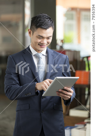 Chinese man with a tablet computer. Chinese man with a tablet computer. 7956394