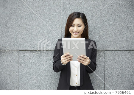Chinese business woman with a tablet computer. Chinese business woman with a tablet computer. 7956461