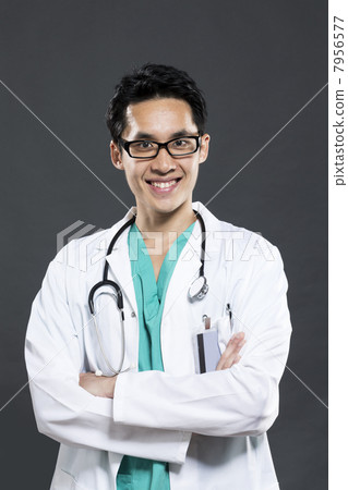 Chinese doctor wearing Green Scrubs & white coat. 7956577