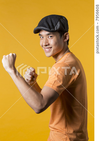 Playful Asian man throwing a punch. 7956608