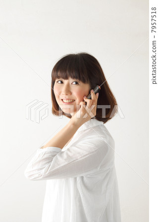 A gentle woman with a cell phone A gentle woman with a cell phone 7957518