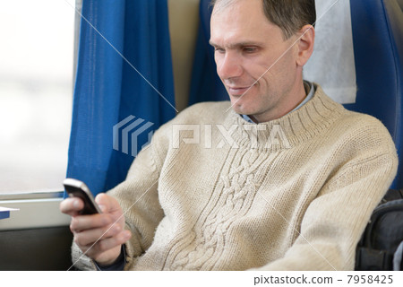 Passenger with cell phone in a train 7958425