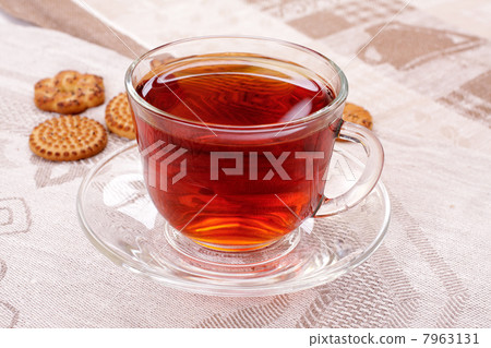 Cup of hot tea and cookies on a napkin Cup of hot tea and cookies on a napkin 7963131