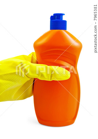 A bottle of orange in yellow-gloved hand in the 7965381