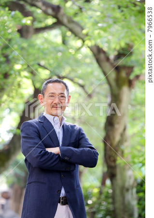 Senior men standing in the fresh green trees Senior men standing in the fresh green trees 7966538