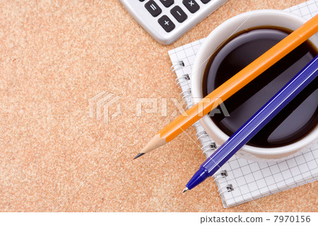 pen, pencil and coffee on checked notebook 7970156