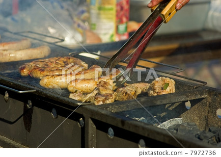Sausages and meat on the grill 7972736