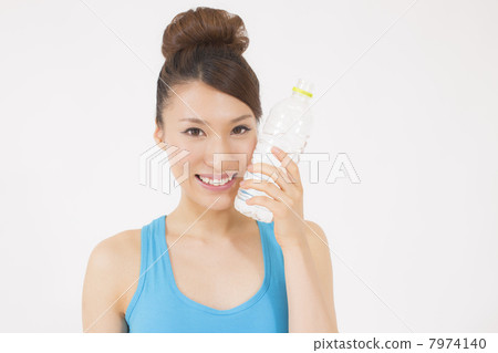 Young women with training wear with plastic bottles 7974140