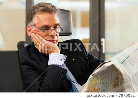 Boss in his office reading newspaper Boss in his office reading newspaper 7976091