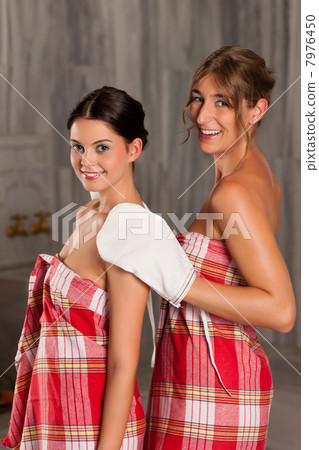 Wellness - two female friends getting a massage and cleansing Wellness - two female friends getting a massage and cleansing 7976450