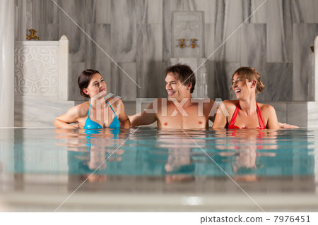 Three friends in swimming pool or thermal bath Three friends in swimming pool or thermal bath 7976451