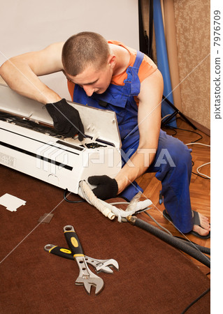 Air conditioning master preparing to install new air conditioner 7976709