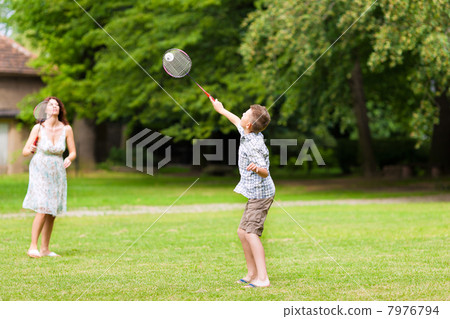 Family is playing in summer in their garden Family is playing in summer in their garden 7976794