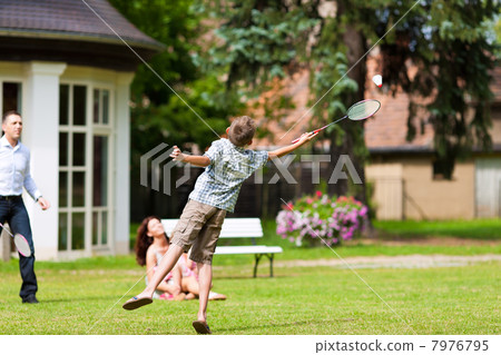 Family is playing in summer in front of their house Family is playing in summer in front of their house 7976795