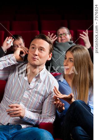 people in cinema theater with mobile phone people in cinema theater with mobile phone 7976834
