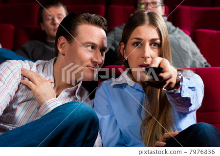 Couple and other people in cinema 7976836
