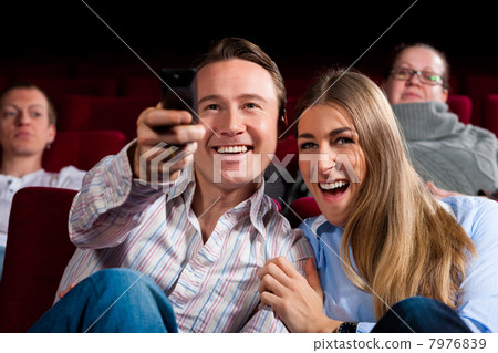 Couple and other people in cinema 7976839