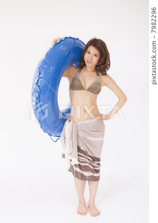 A woman in a bathing suit with a floating ring A woman in a bathing suit with a floating ring 7982296