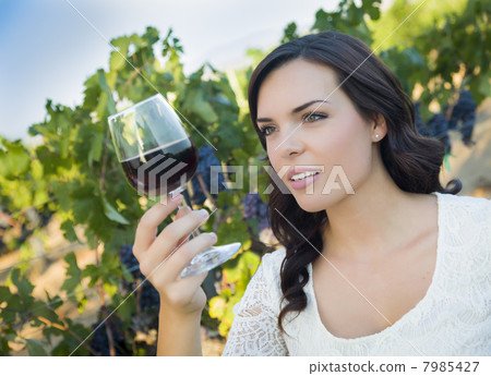 Young Adult Woman Enjoying A Glass of Wine in Vineyard 7985427