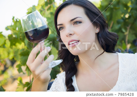 Young Adult Woman Enjoying A Glass of Wine in Vineyard 7985428