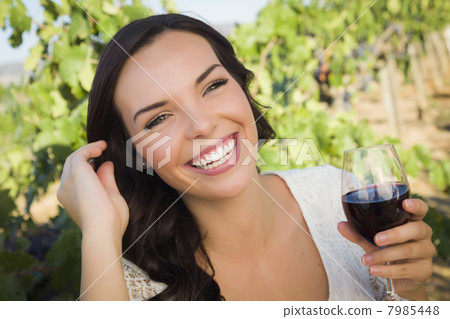 Young Adult Woman Enjoying A Glass of Wine in Vineyard Young Adult Woman Enjoying A Glass of Wine in Vineyard 7985448