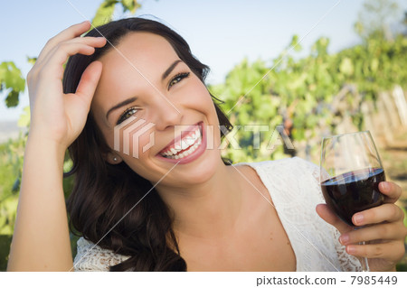 Young Adult Woman Enjoying A Glass of Wine in Vineyard Young Adult Woman Enjoying A Glass of Wine in Vineyard 7985449