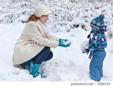 Mother and toddler boy having fun with snow on winter day Mother and toddler boy having fun with snow on winter day 7986354