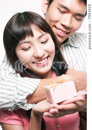 Portrait of a young couple embracing 7993928