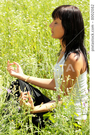 Young woman in pose lotus. Young woman in pose lotus. 8002082