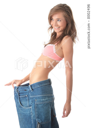 Woman showing how much weight she lost. Woman showing how much weight she lost. 8002496