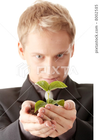 Man in suit holding smal plant in his hands Man in suit holding smal plant in his hands 8002585