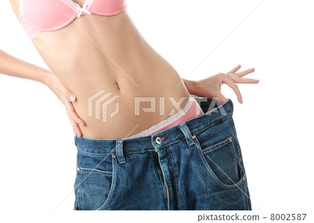 Woman showing how much weight she lost. Woman showing how much weight she lost. 8002587