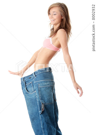 Woman showing how much weight she lost. 8002932