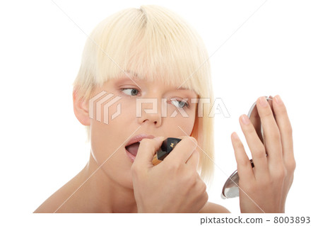 A beautiful young woman applying her make-up 8003893
