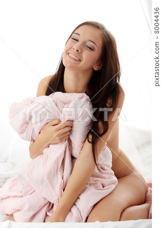 Young brunette sitting on the bed Young brunette sitting on the bed 8004436