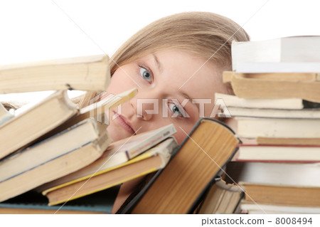 Young woman sitting behind books 8008494
