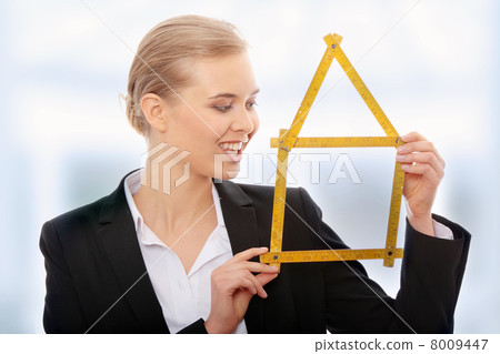 Beautiful businesswoman with house model 8009447