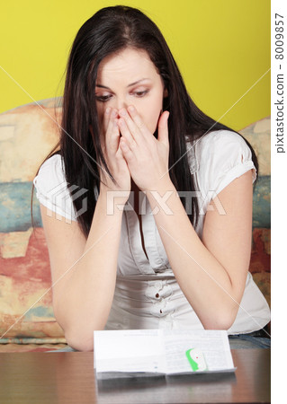 Woman looking at a pregnancy test Woman looking at a pregnancy test 8009857