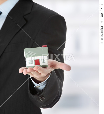 Young business man with house model Young business man with house model 8011304