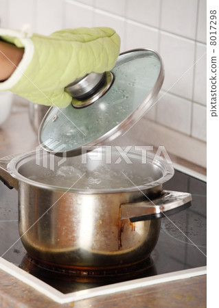 Young woman boiling something in pot Young woman boiling something in pot 8017298