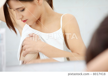 Woman examining her breast 8017418