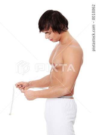 Young mans measuring himself. 8018862