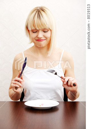 Woman eating nutritional supplement 8019313
